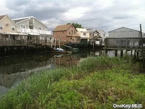 a view of a town with large trees and buildings