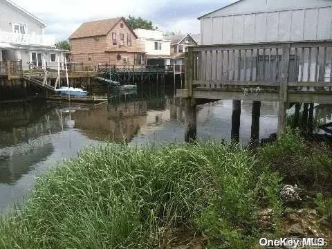 a view of a house with yard and lake view