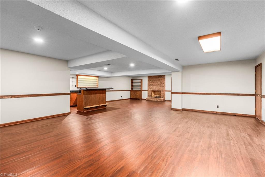 4200 Clinard Road Clemmons, NC 27012 - Photo 42 of 49 Basement with fireplace and full bar with sink, bedroom #5 and full bath