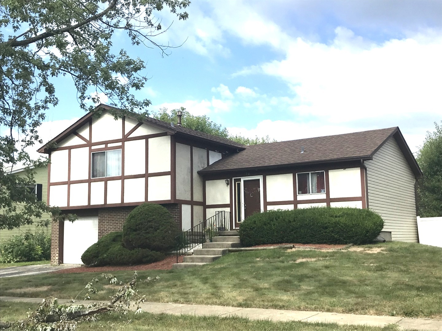 54 Cloverleaf Road Matteson, IL 60443 - Photo 2 of 13 a view of a brick house next to a yard with plants and trees