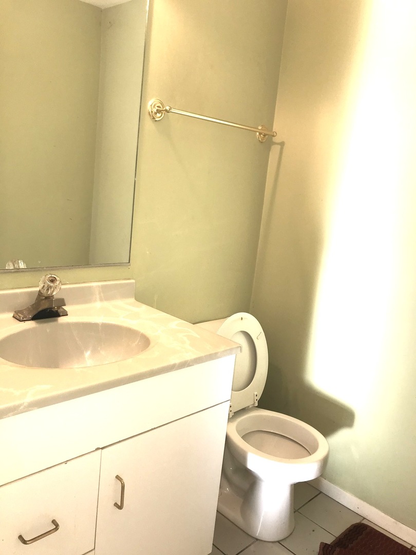 54 Cloverleaf Road Matteson, IL 60443 - Photo 10 of 13 a white toilet sitting next to a bathroom sink