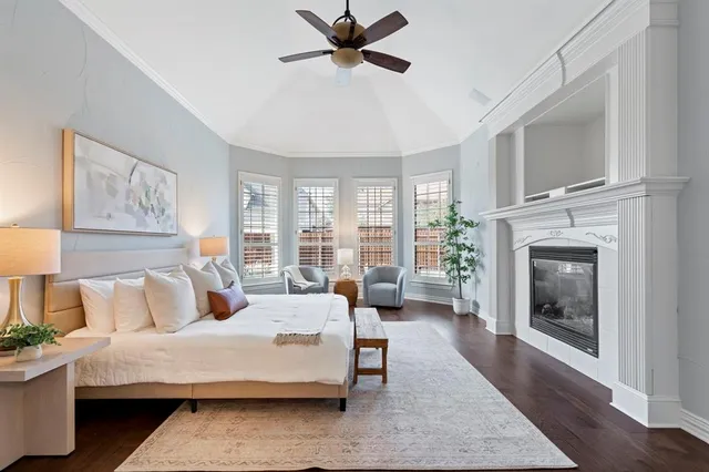 a bedroom with a large bed and a fireplace