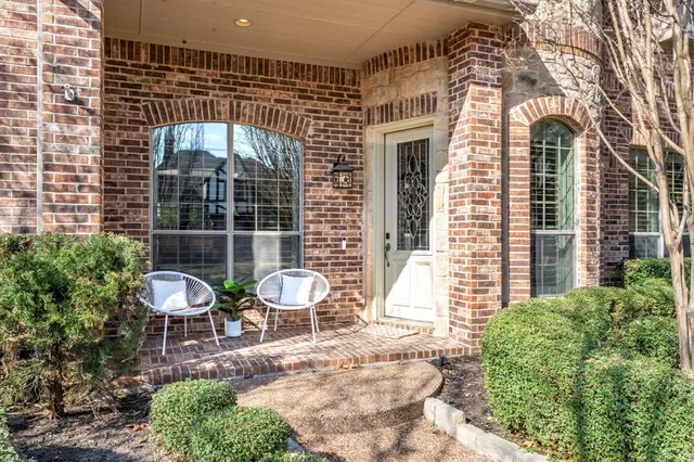 a front view of a house with outdoor seating and plants