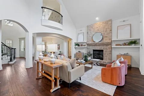 a living room with furniture a fireplace and wooden floor