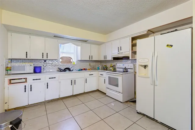 a kitchen with cabinets stainless steel appliances and a counter space