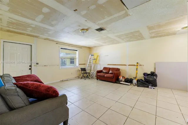 a spacious bedroom with a bed and a couch