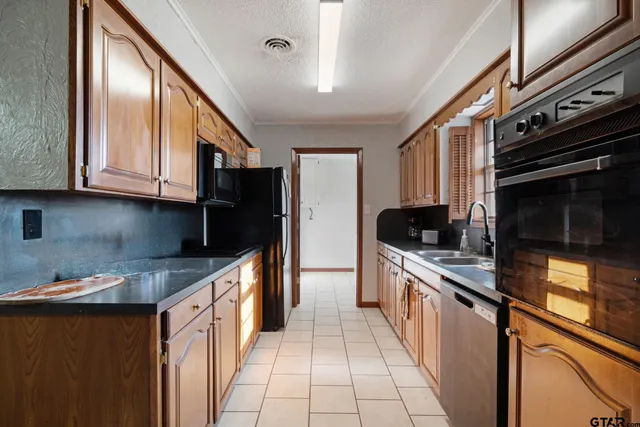 a kitchen with stainless steel appliances granite countertop a stove and a sink