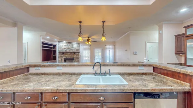 a kitchen with kitchen island granite countertop a sink and center island
