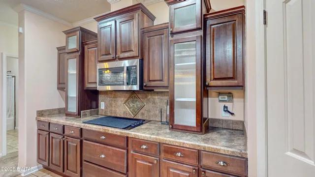 a kitchen with granite countertop stainless steel appliances a sink and a refrigerator