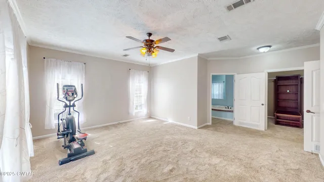 a view of empty room with ceiling fan