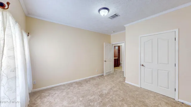 an empty room with windows and closet