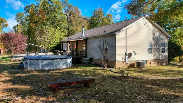 a view of a house with backyard and sitting area