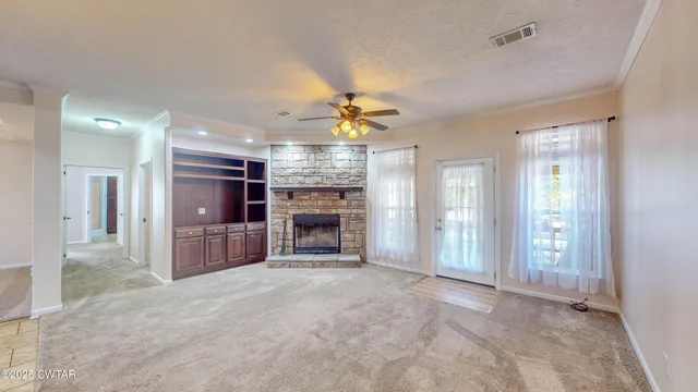 a view of a livingroom with a fireplace and window