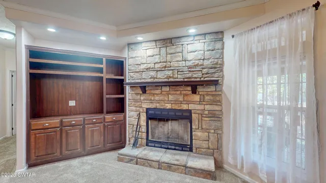 a open kitchen with granite countertop a fireplace and a shower
