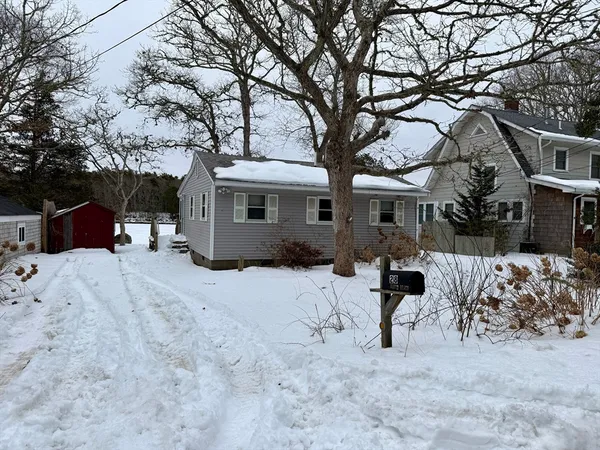 a view of a house with a snow in the yard