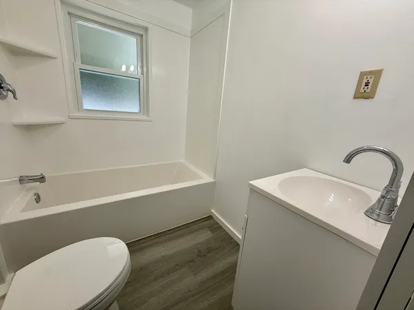 a bathroom with a sink mirror vanity and toilet