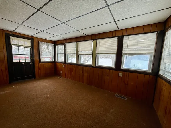 a big room with wooden floor and windows