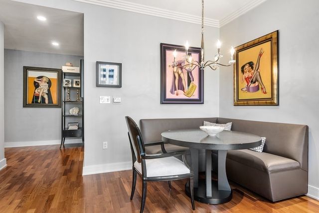 a dining room with furniture and wooden floor