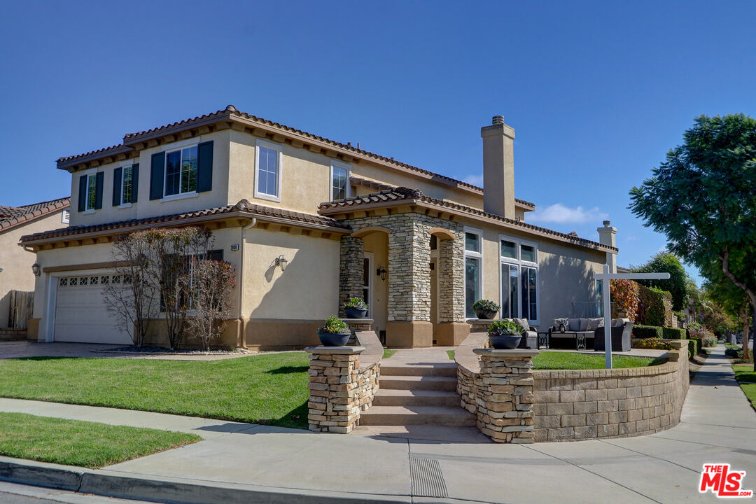 a front view of a house with a garden