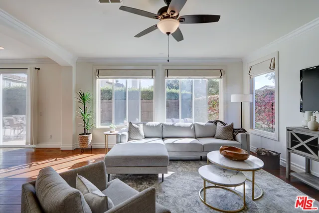 a kitchen with white cabinets and sink