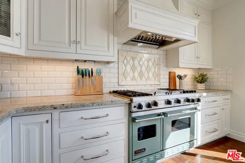 a bedroom with bed and a chandelier