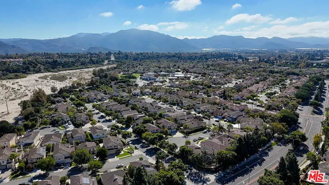 an aerial view of residential house with outdoor space and mountain view