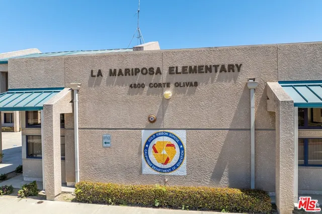 a view of a patio with dining table and chairs