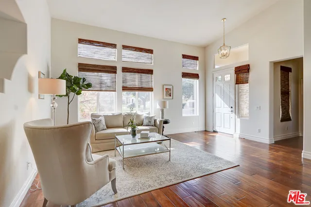 a living room with furniture wooden floor and a table