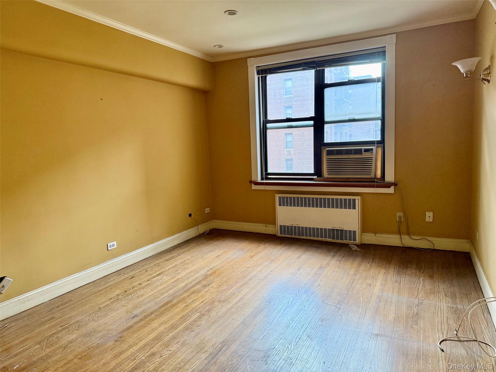 112-50 Northern Boulevard, Unit 3B Queens, NY 11368 - Photo 2 of 20 Large living room with double panel windows, hardwood floors, recessed lighting