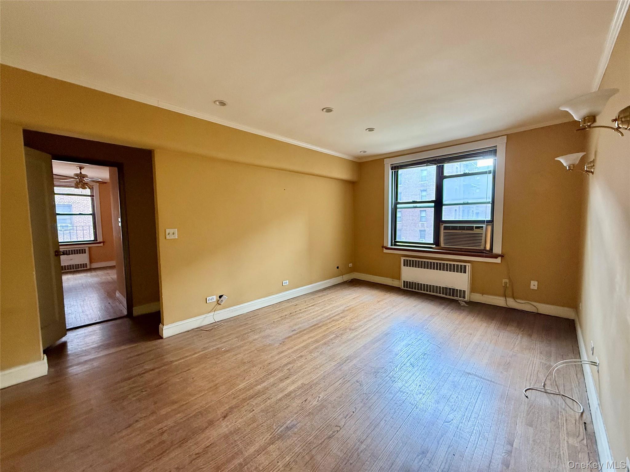 112-50 Northern Boulevard, Unit 3B Queens, NY 11368 - Photo 3 of 20 Large living room with double panel windows, hardwood floors, recessed lighting