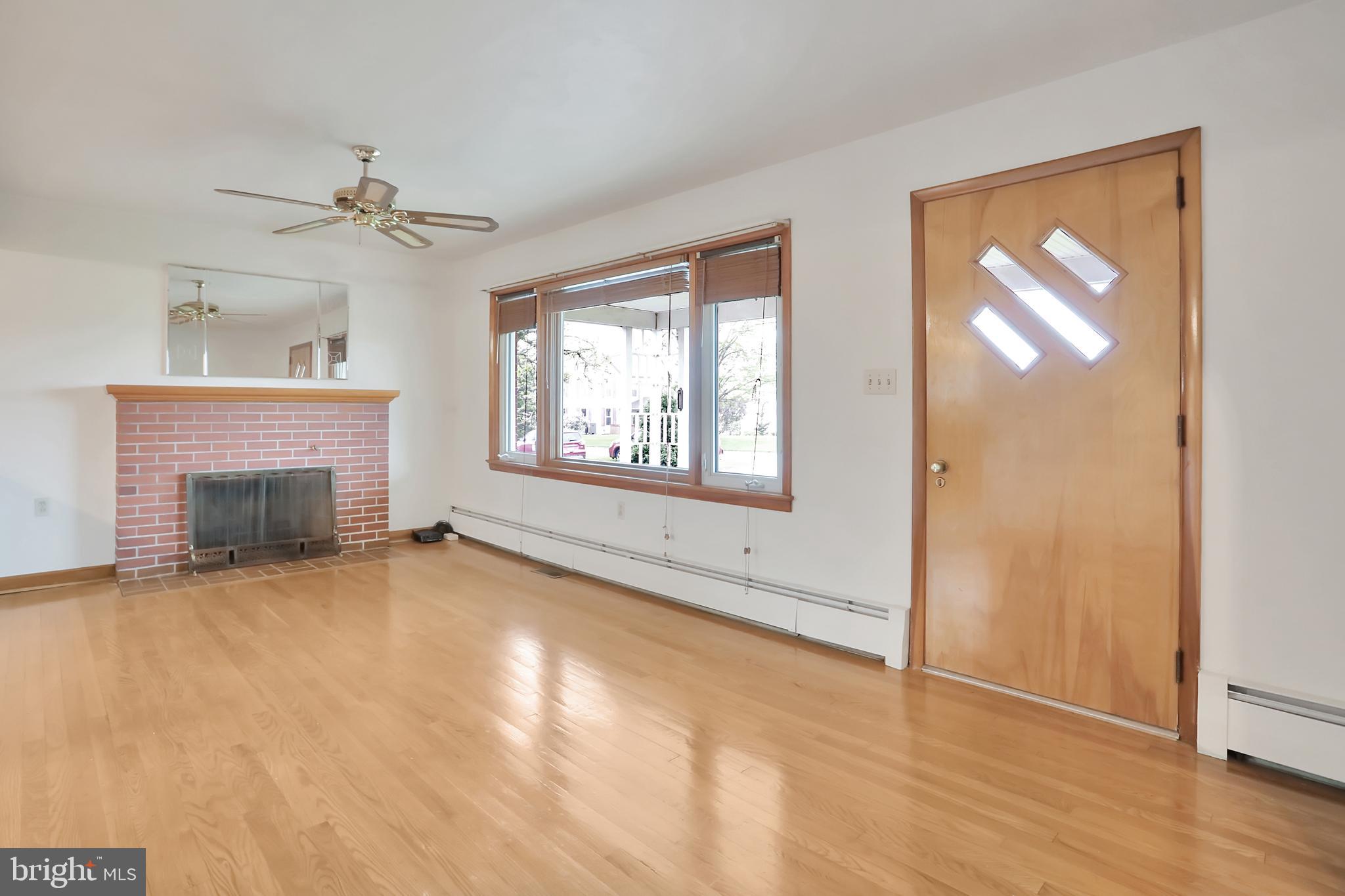 1229 Tallow Hill Road Chambersburg, PA 17202 - Photo 14 of 50 Living room with fireplace, hardwood floors