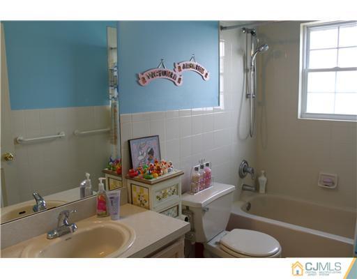 17 Potomac Road Monmouth Junction, NJ 08852 - Photo 14 of 19 a bathroom with a sink and a mirror