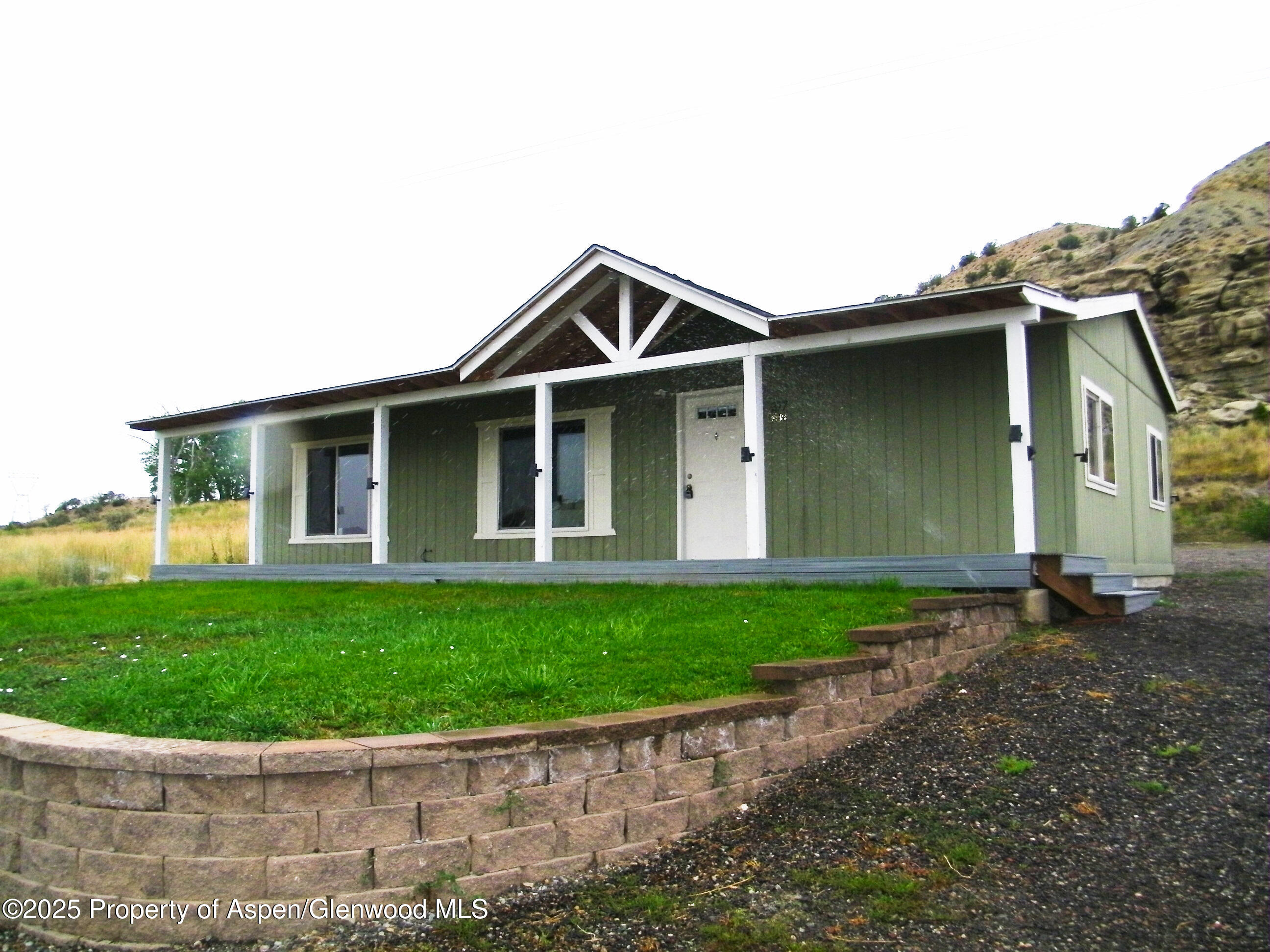 a front view of a house with a garden and yard