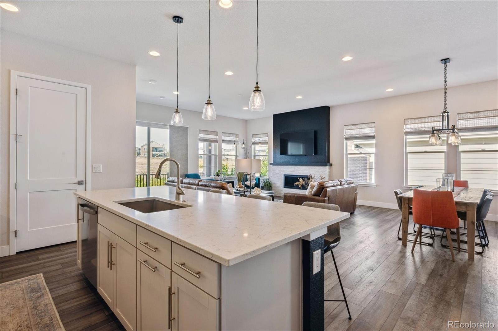 2095 Rim Ridge Drive Castle Pines, CO 80108 - Photo 12 of 46 a kitchen with center island table and chairs