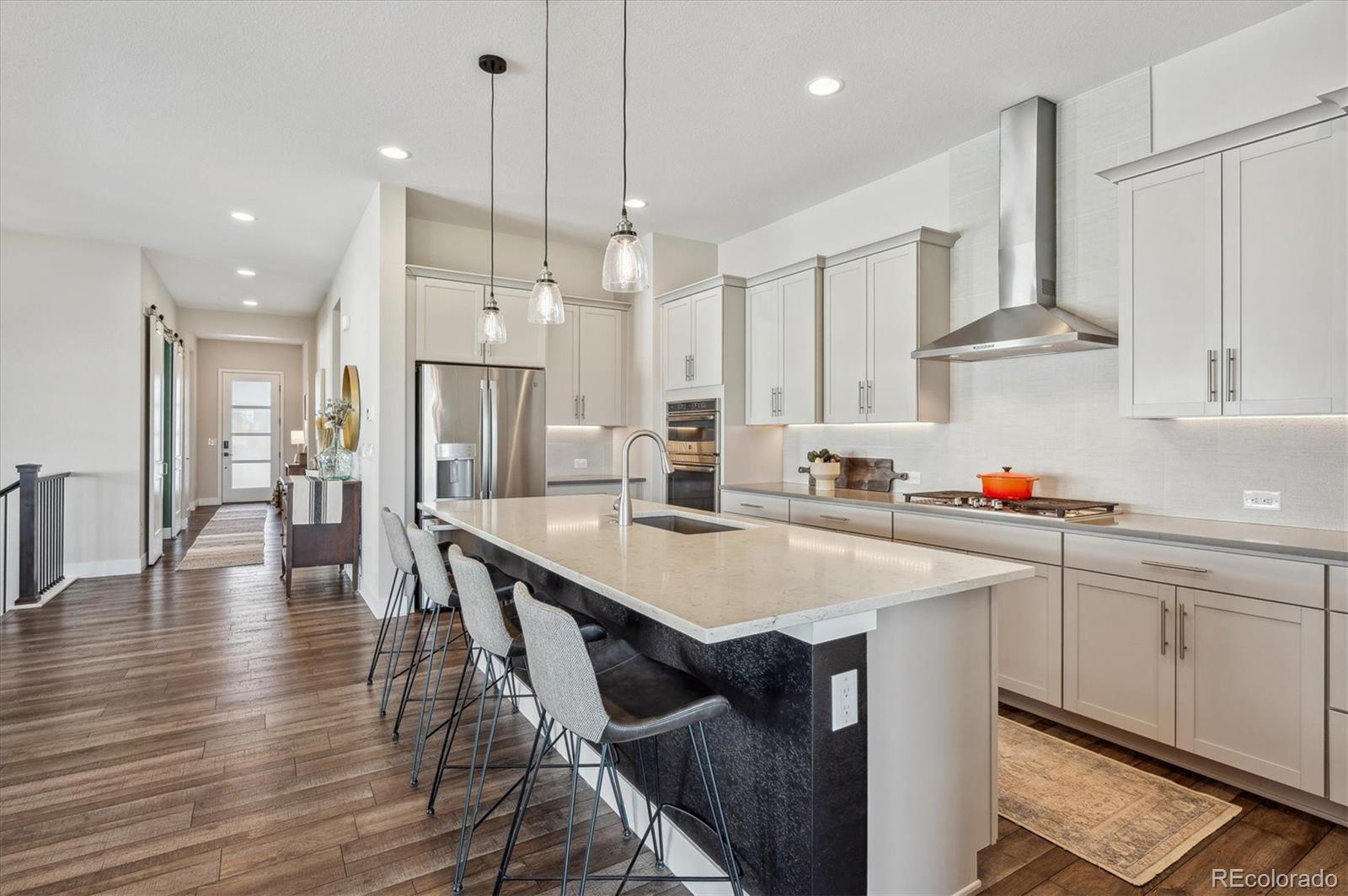 2095 Rim Ridge Drive Castle Pines, CO 80108 - Photo 13 of 46 a kitchen with stainless steel appliances granite countertop a sink a stove and a refrigerator