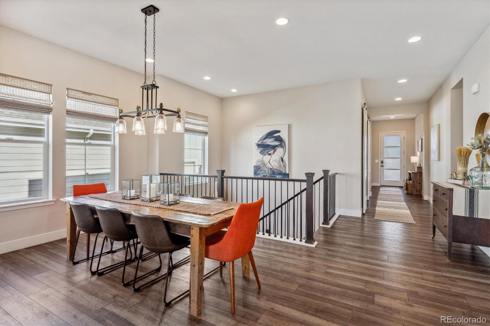 2095 Rim Ridge Drive Castle Pines, CO 80108 - Photo 15 of 46 a view of a dining room and livingroom with furniture wooden floor a chandelier