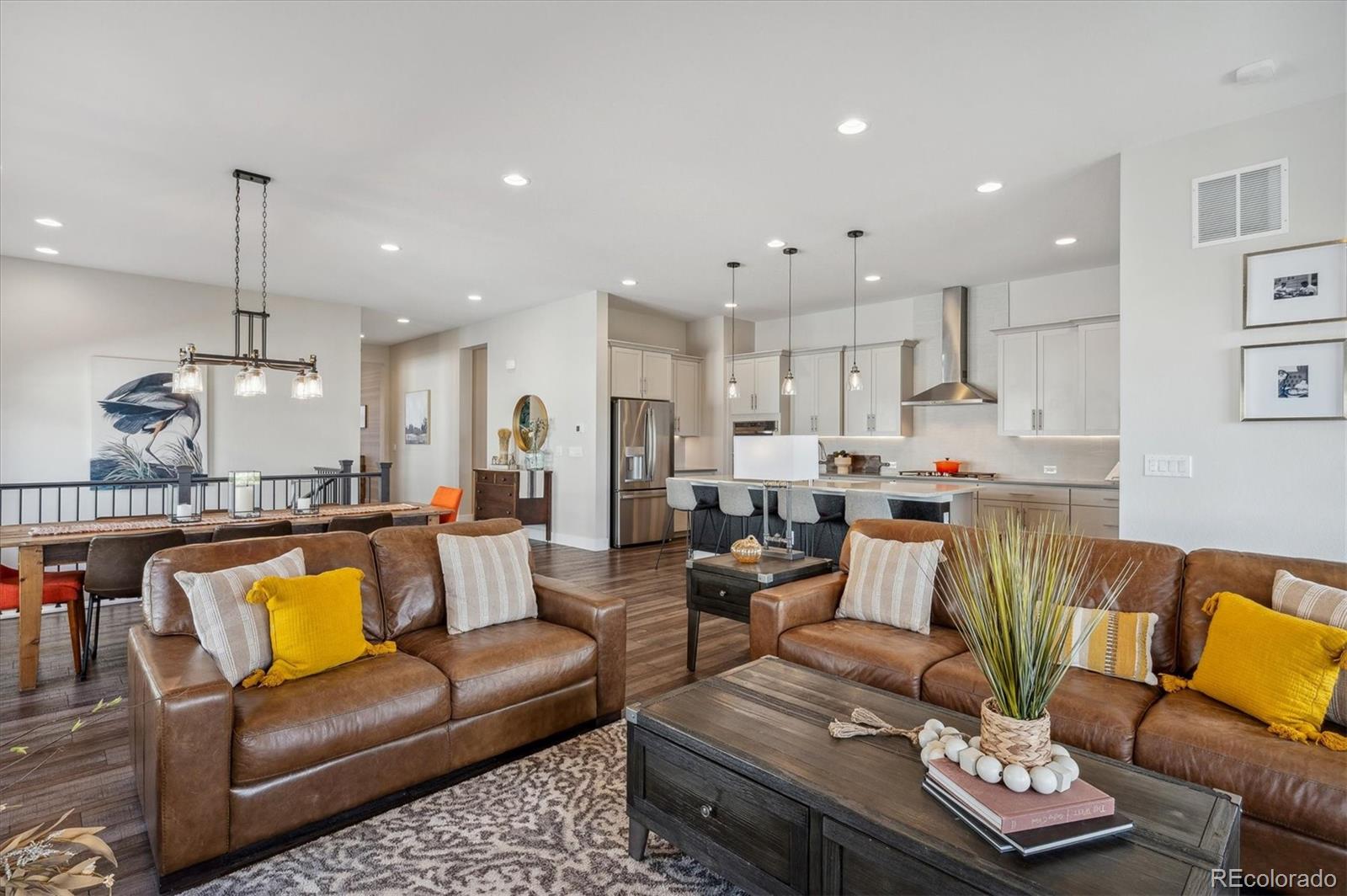 2095 Rim Ridge Drive Castle Pines, CO 80108 - Photo 18 of 46 a living room with furniture kitchen view and a wooden floor