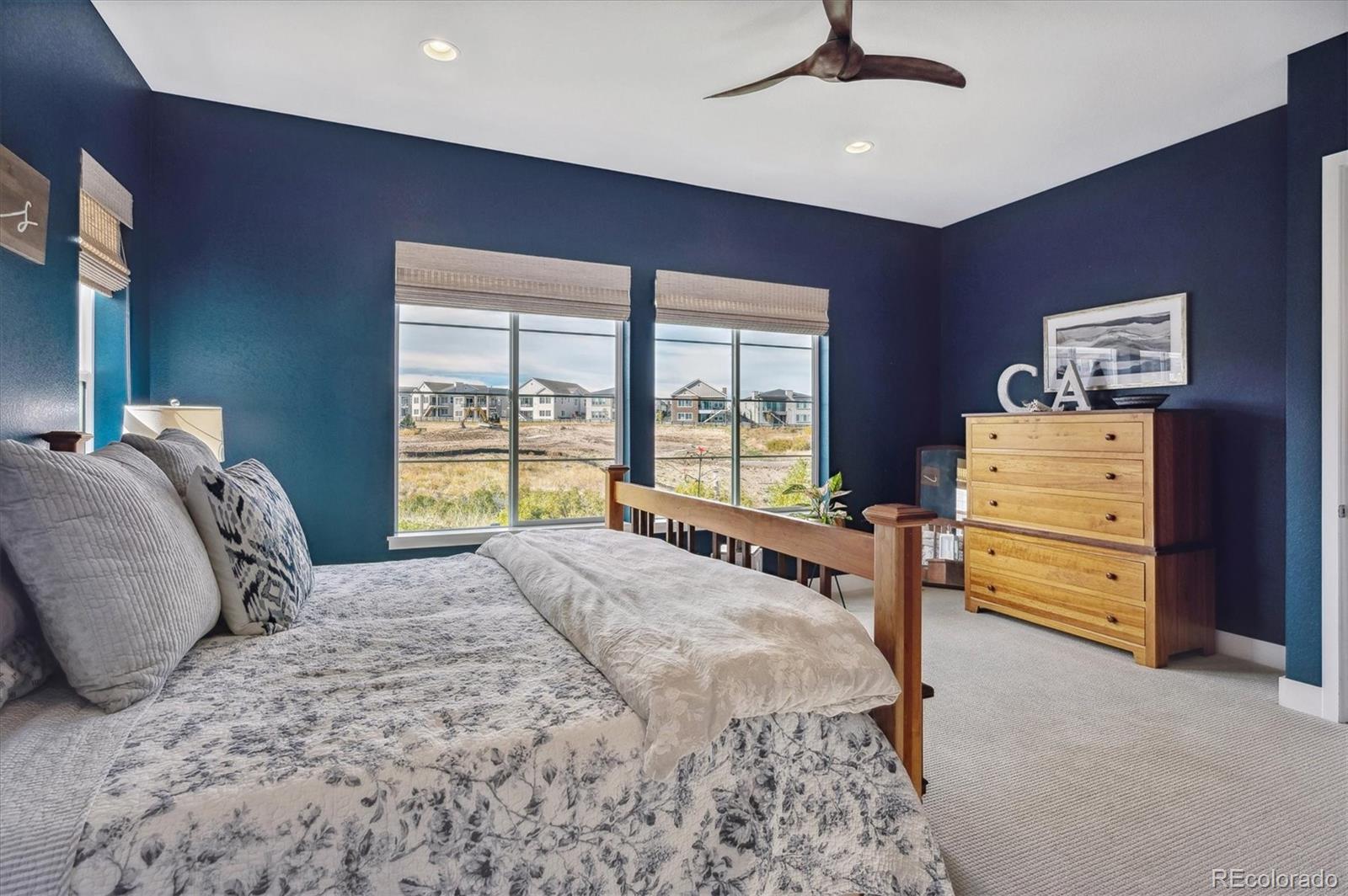 2095 Rim Ridge Drive Castle Pines, CO 80108 - Photo 20 of 46 a bedroom with a bed and a dresser