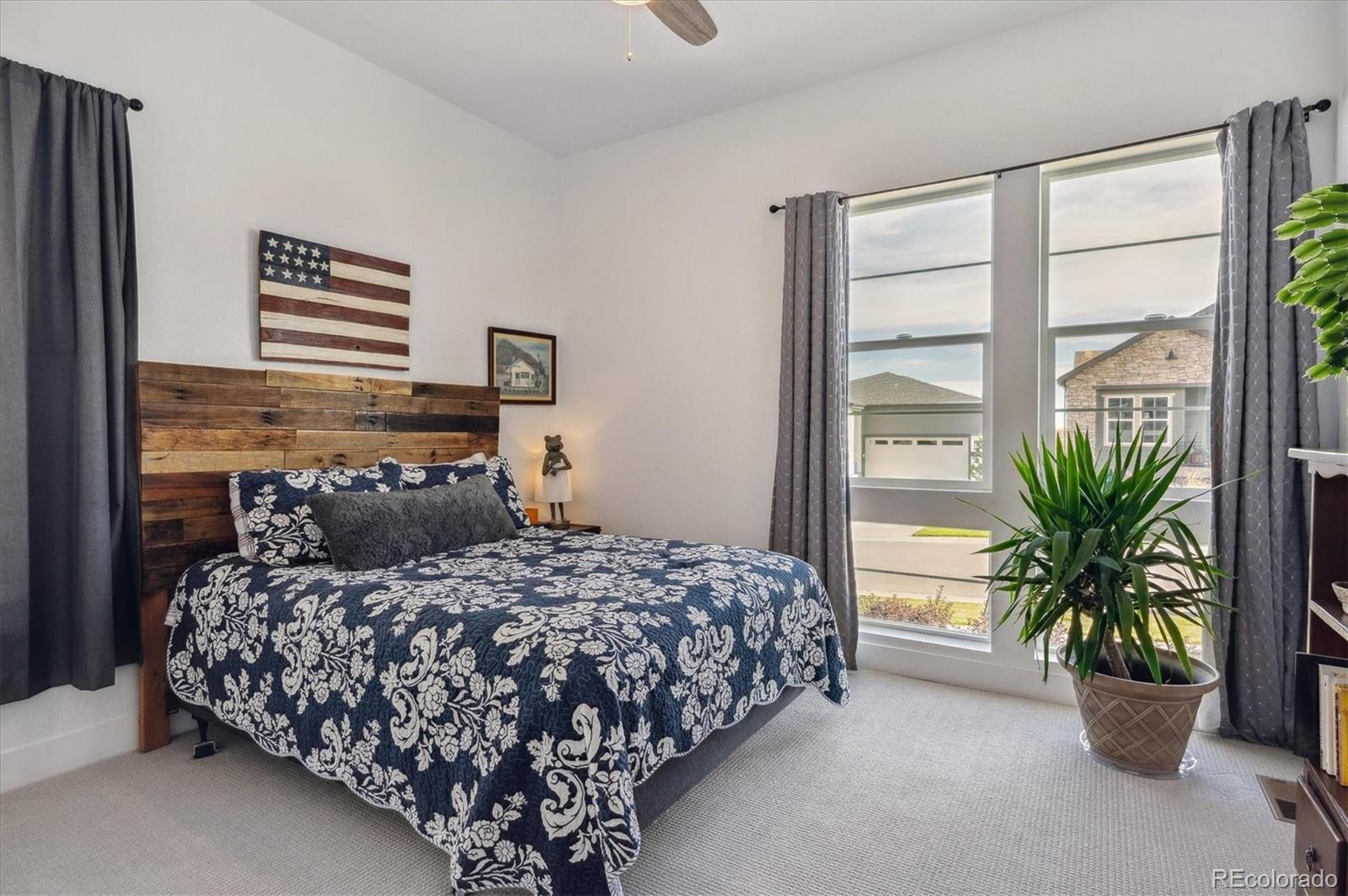 2095 Rim Ridge Drive Castle Pines, CO 80108 - Photo 24 of 46 a bedroom with a bed and a potted plant