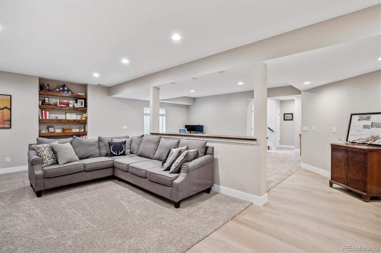 2095 Rim Ridge Drive Castle Pines, CO 80108 - Photo 31 of 46 a living room with furniture and a flat screen tv