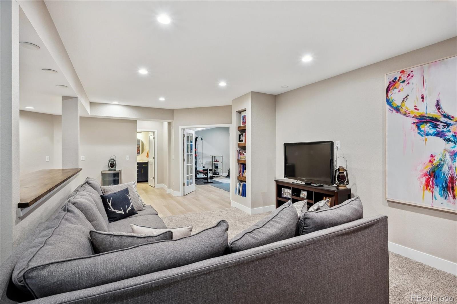 2095 Rim Ridge Drive Castle Pines, CO 80108 - Photo 32 of 46 a living room with furniture and a flat screen tv