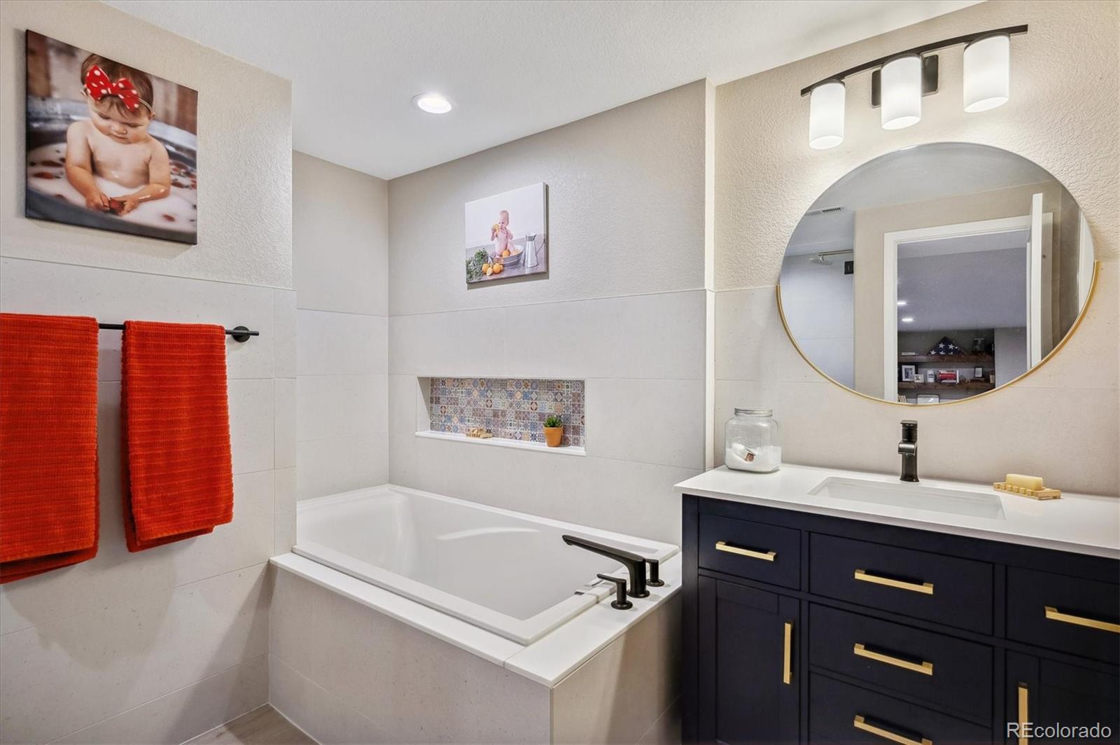 2095 Rim Ridge Drive Castle Pines, CO 80108 - Photo 34 of 46 a bathroom with a tub sink and mirror