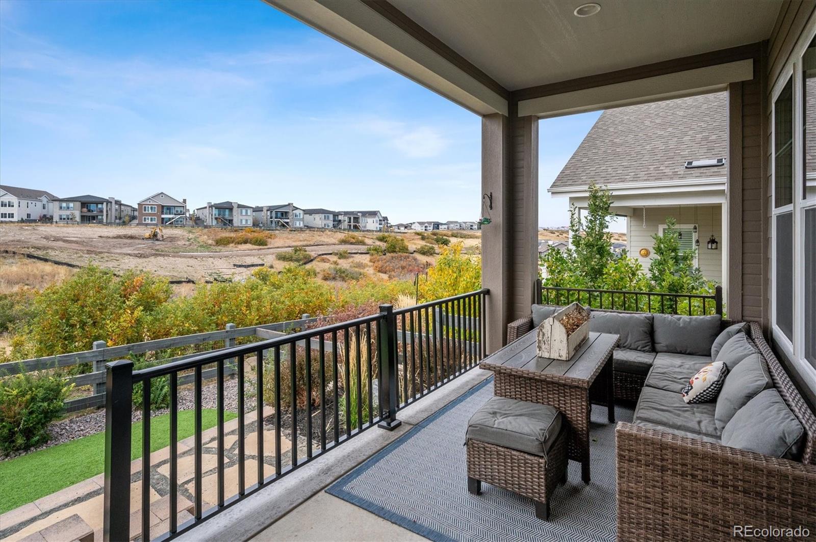 2095 Rim Ridge Drive Castle Pines, CO 80108 - Photo 36 of 46 a view of a balcony with couch and wooden floor