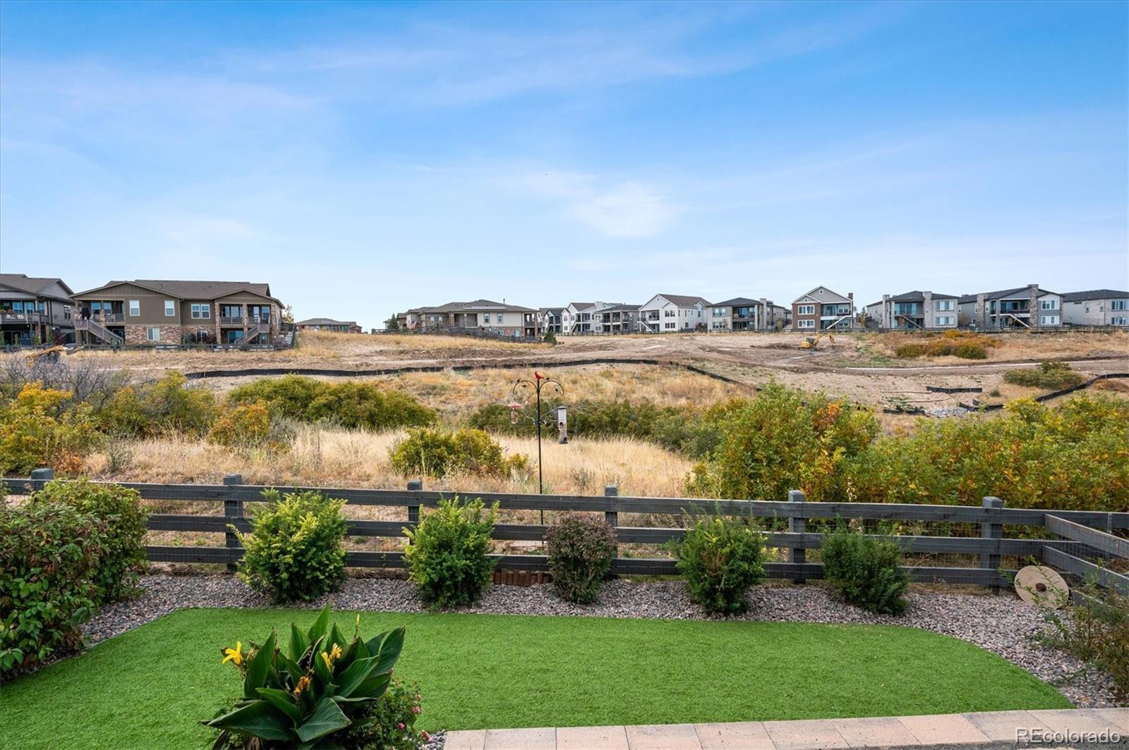 2095 Rim Ridge Drive Castle Pines, CO 80108 - Photo 38 of 46 a view of a lake with a city