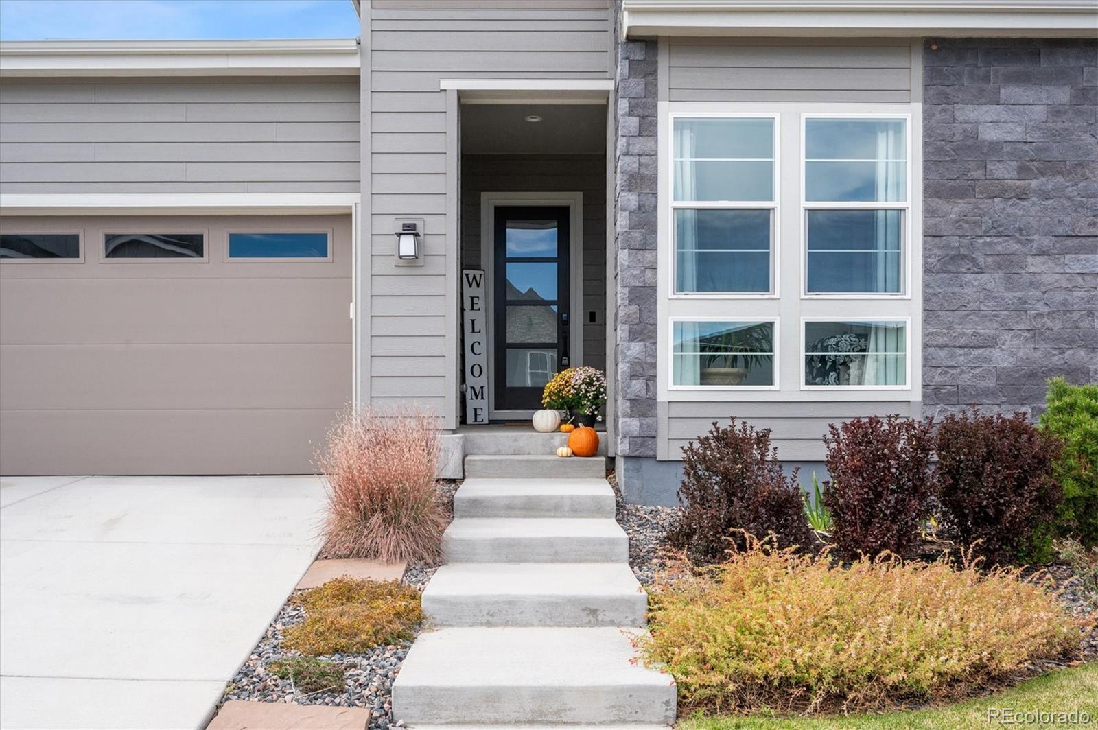 2095 Rim Ridge Drive Castle Pines, CO 80108 - Photo 7 of 46 a front view of a house with a yard