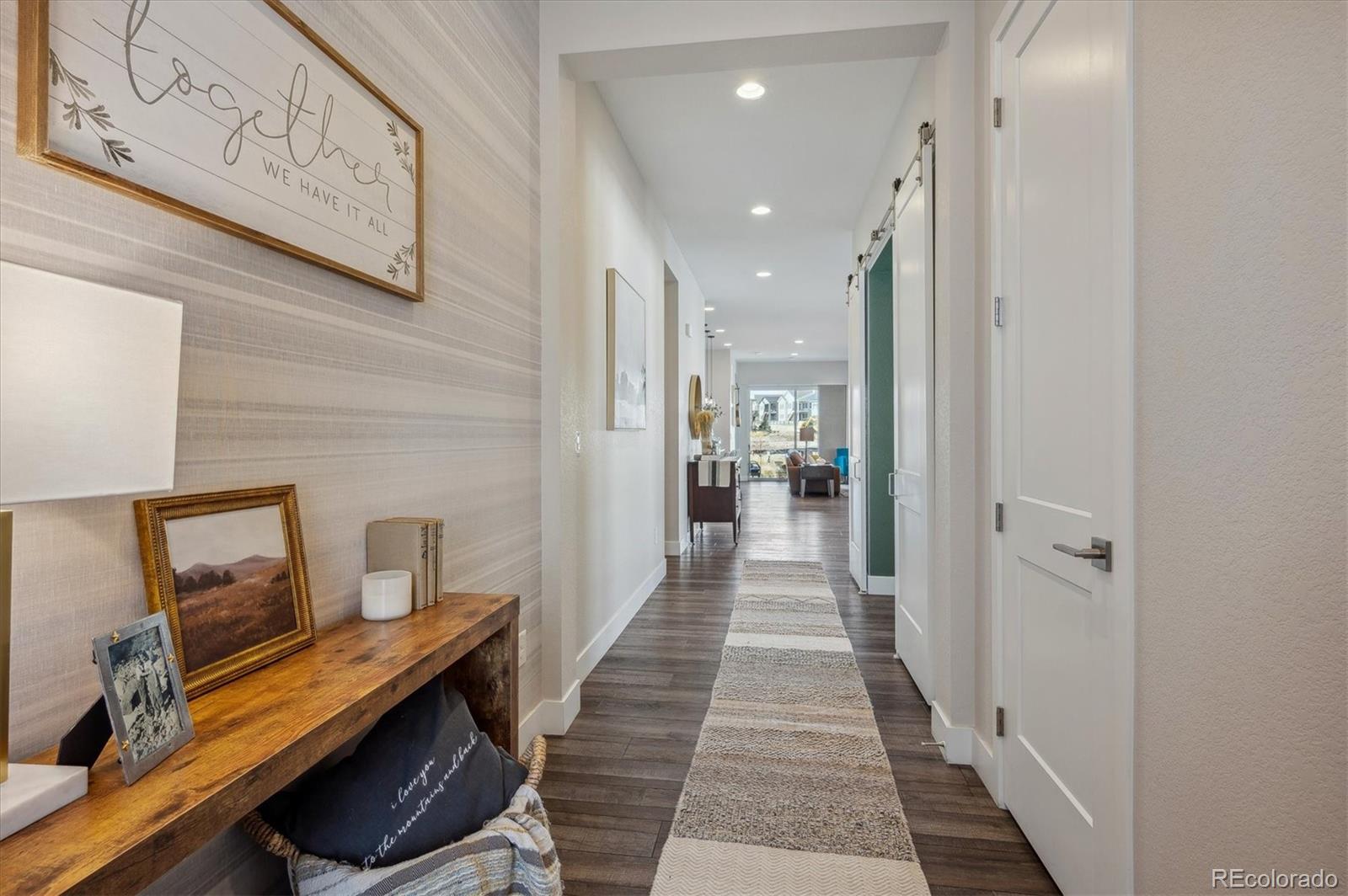 2095 Rim Ridge Drive Castle Pines, CO 80108 - Photo 8 of 46 a view of a hallway with workspace and a mirror