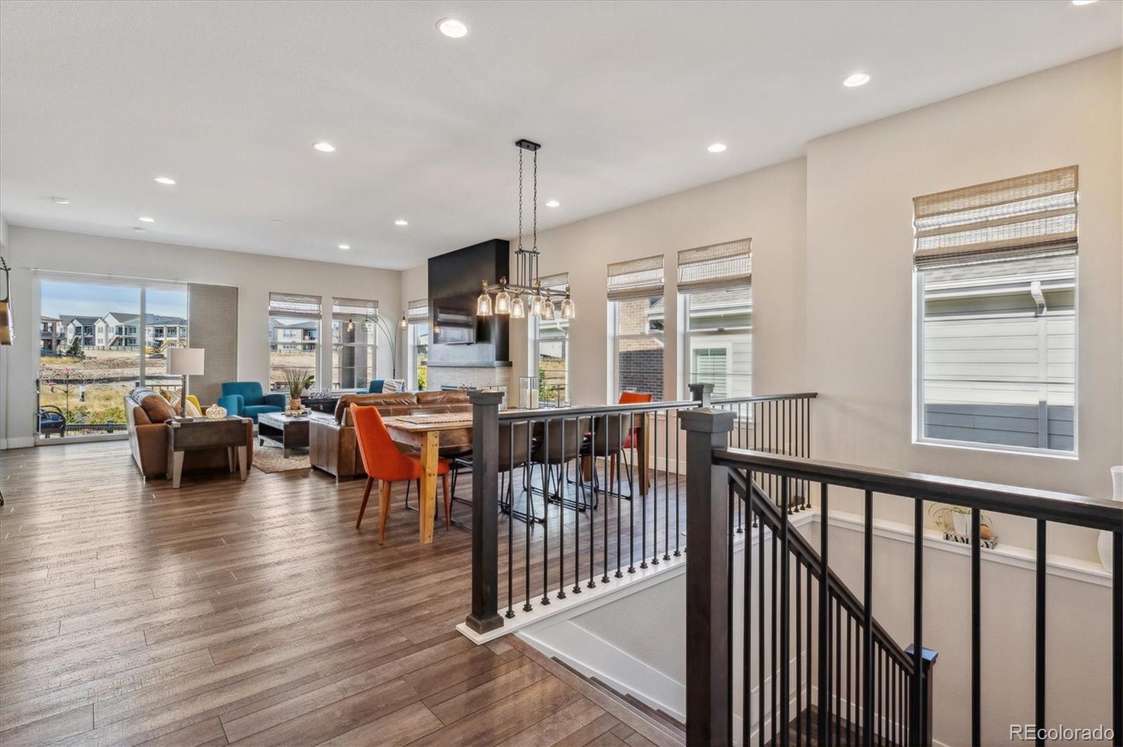 2095 Rim Ridge Drive Castle Pines, CO 80108 - Photo 10 of 46 a living room with furniture kitchen view and a wooden floor