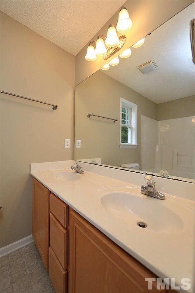 1009 Dual Parks Road Apex, NC 27502 - Photo 11 of 15 Master bath/spa has double vanities and fresh paint.