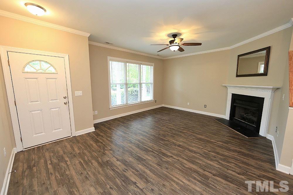 1009 Dual Parks Road Apex, NC 27502 - Photo 15 of 15 Spacious living room with open floor plan and gas logs in the fireplace will be a cozy place to come home to!