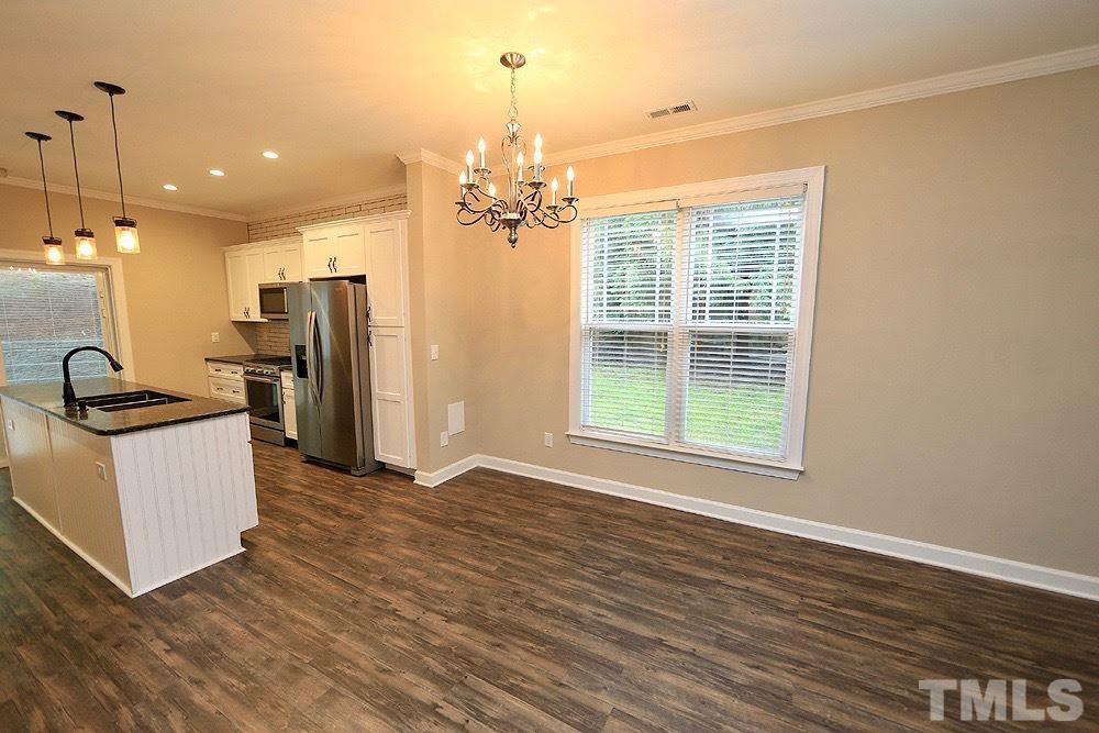 1009 Dual Parks Road Apex, NC 27502 - Photo 4 of 15 Like new neutral eat in kitchen has plenty of space.